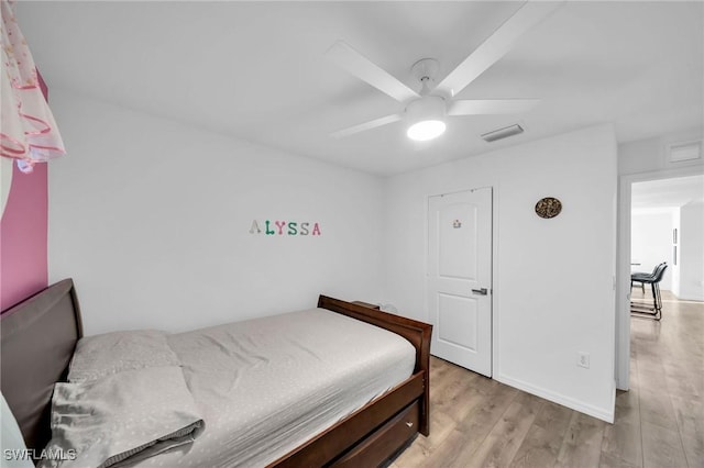 bedroom with light wood-type flooring and ceiling fan