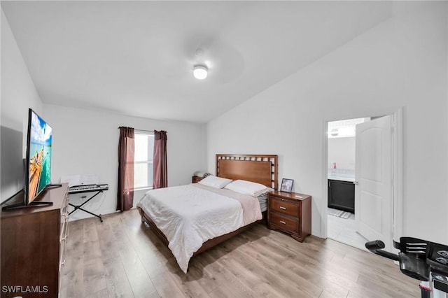 bedroom featuring ensuite bathroom and light wood-type flooring