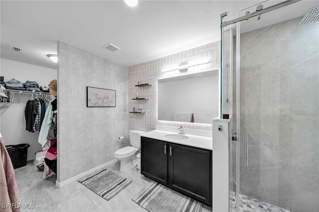 bathroom with toilet, vanity, and walk in shower