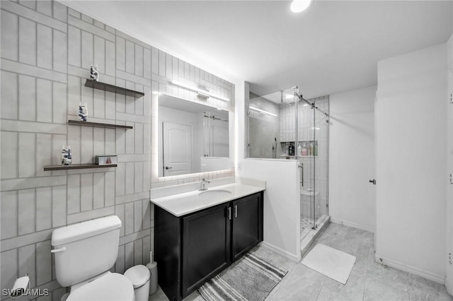 bathroom with tile patterned floors, vanity, toilet, and a shower with door