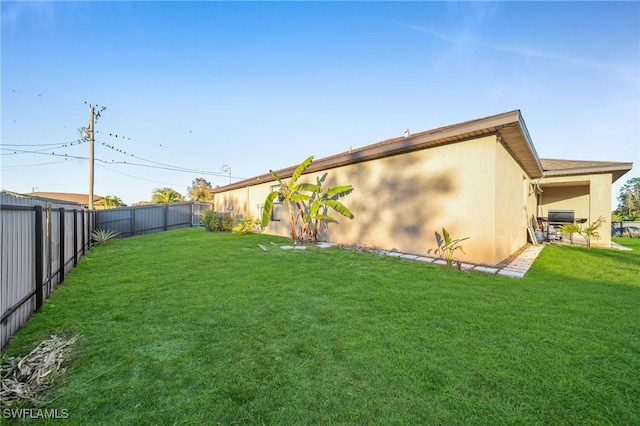 rear view of house featuring a lawn