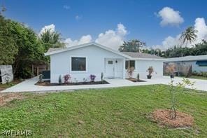 rear view of house featuring a lawn