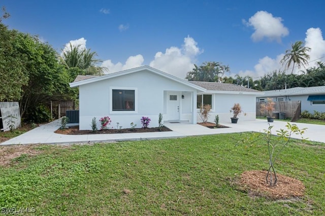 ranch-style house with a front yard and central air condition unit