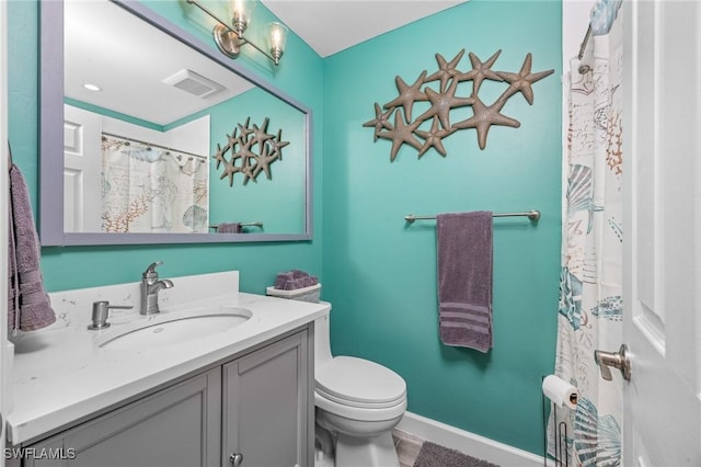 bathroom featuring tile patterned floors, vanity, and toilet