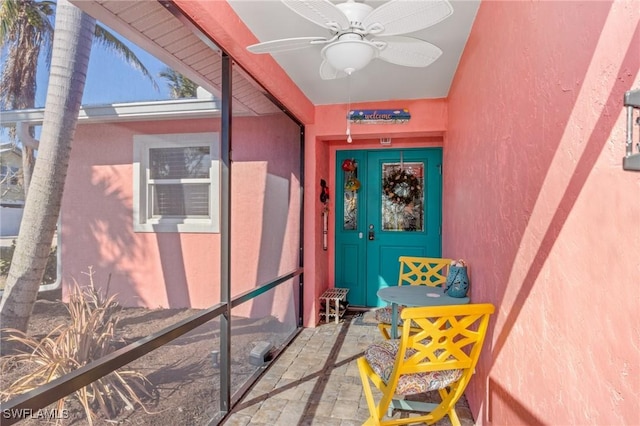 view of exterior entry with ceiling fan