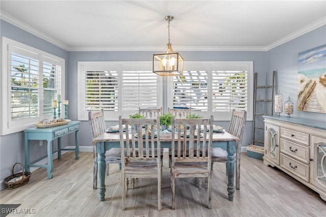 dining room with a chandelier, light hardwood / wood-style flooring, plenty of natural light, and ornamental molding