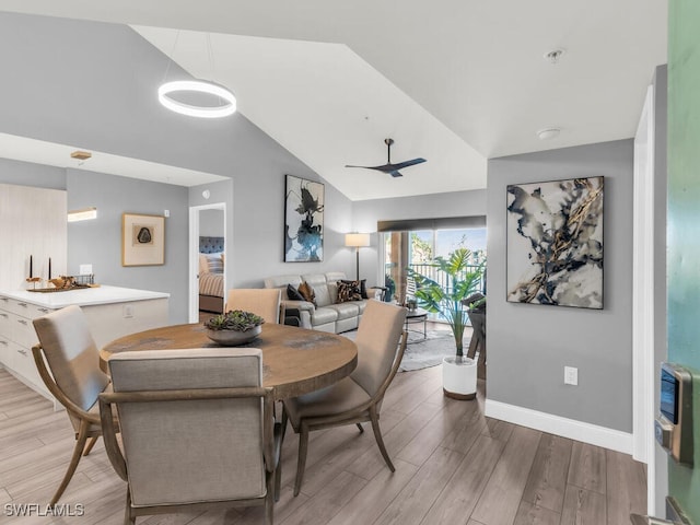 dining room with wood-type flooring, heating unit, ceiling fan, and lofted ceiling