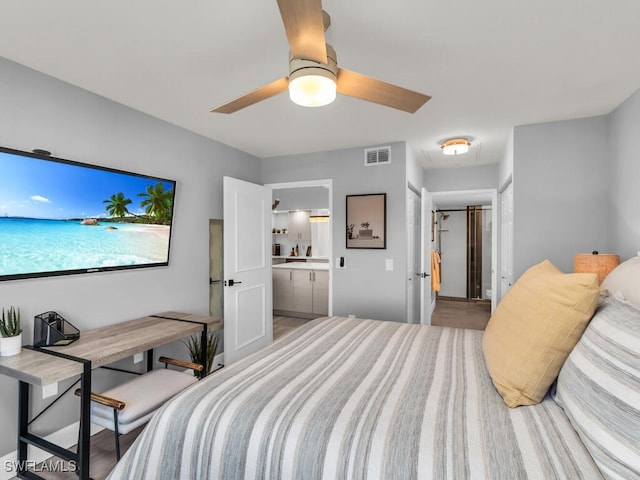 bedroom featuring hardwood / wood-style flooring, ceiling fan, and ensuite bath