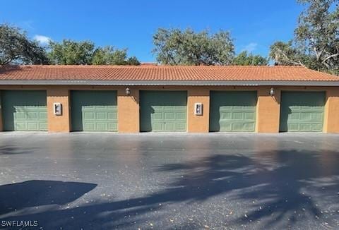 exterior space featuring a garage and an outdoor structure