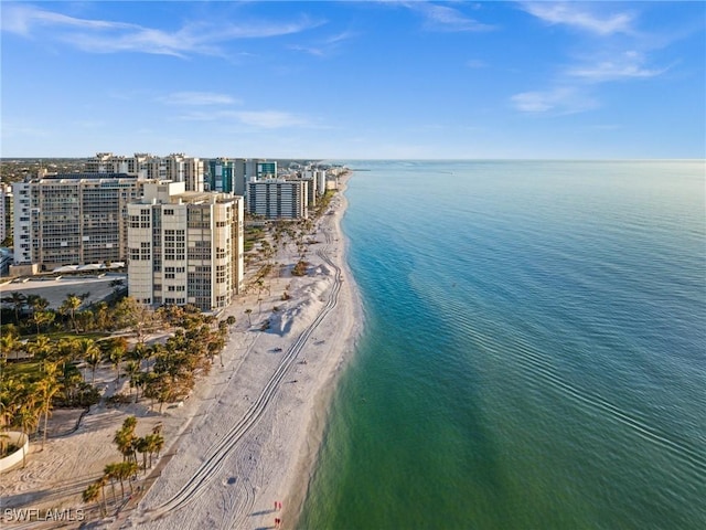 birds eye view of property featuring a water view and a beach view