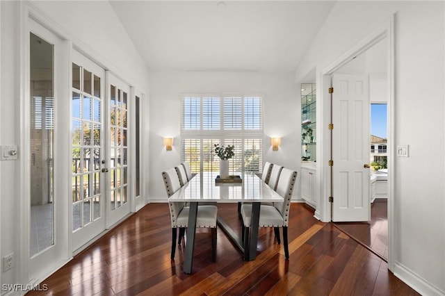 dining area with lofted ceiling, dark wood-style floors, and baseboards