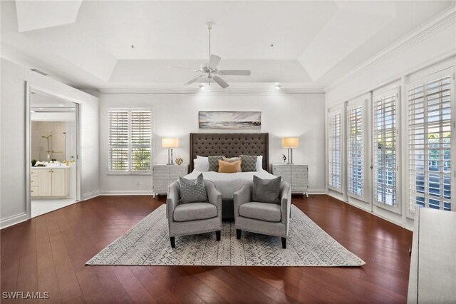 bedroom with ensuite bathroom, access to exterior, ceiling fan, a raised ceiling, and dark wood-type flooring