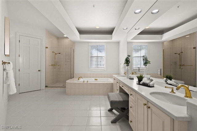 bathroom featuring tile patterned floors, vanity, a tray ceiling, and shower with separate bathtub