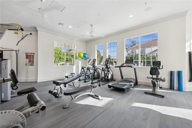 workout area featuring crown molding