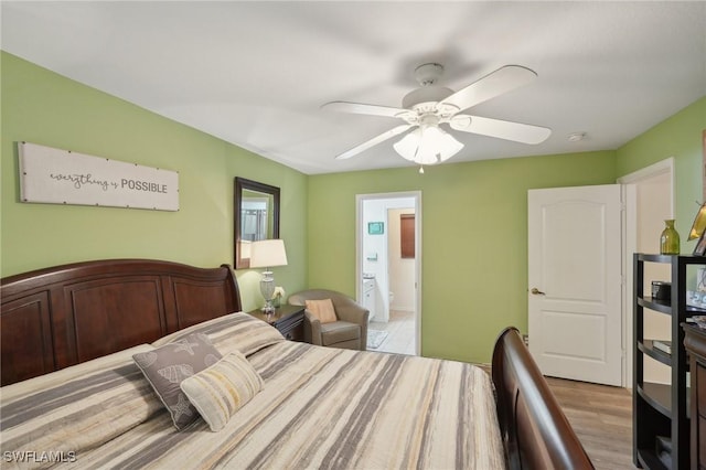 bedroom with ensuite bathroom, light hardwood / wood-style flooring, and ceiling fan