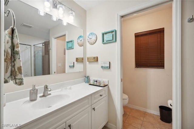 bathroom featuring tile patterned floors, a shower, vanity, and toilet