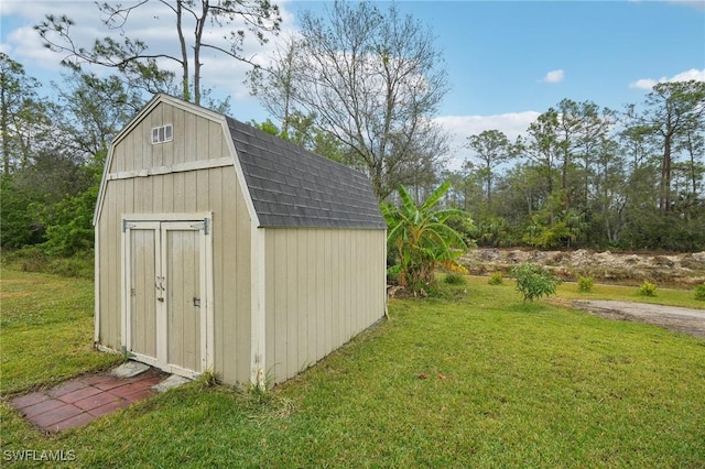 view of outbuilding with a yard