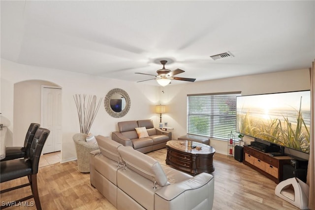 living room with ceiling fan and light hardwood / wood-style flooring