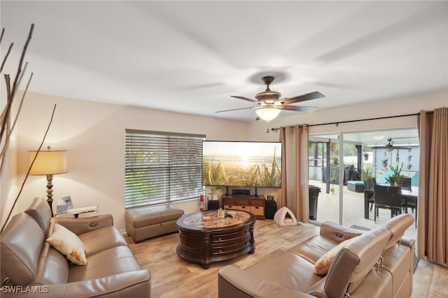 living room featuring light wood-type flooring and ceiling fan