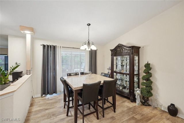 dining space featuring light hardwood / wood-style flooring and a chandelier