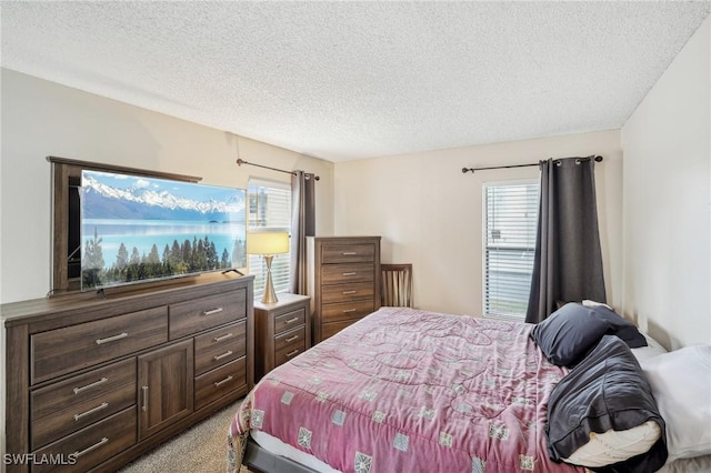 bedroom with light carpet and a textured ceiling