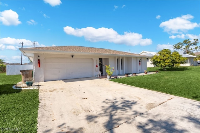 ranch-style house featuring a garage and a front lawn