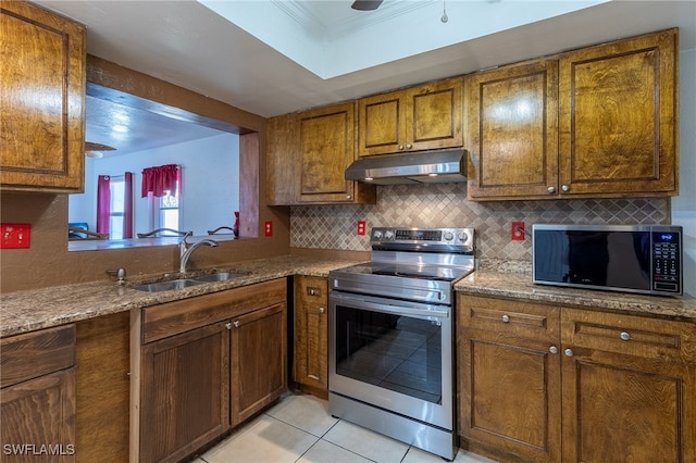 kitchen featuring stainless steel range with electric stovetop, backsplash, stone counters, sink, and light tile patterned floors