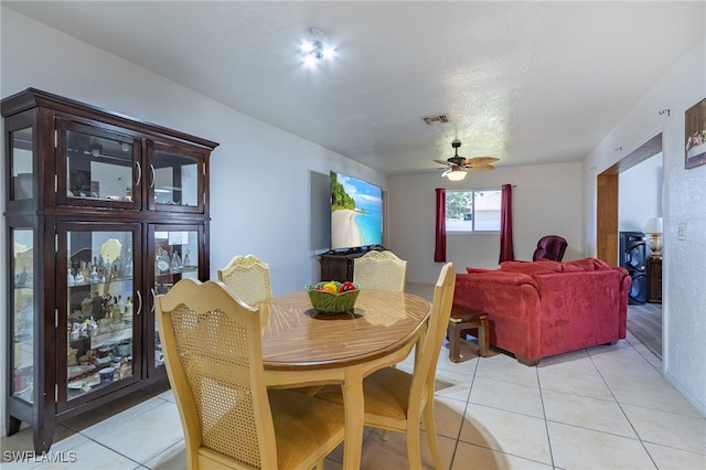 tiled dining room with ceiling fan