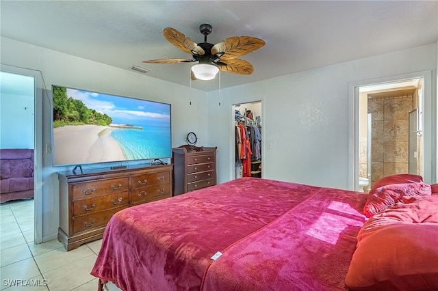 bedroom with ensuite bathroom, ceiling fan, a spacious closet, a closet, and light tile patterned flooring