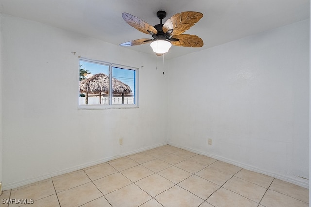 empty room featuring ceiling fan and light tile patterned floors