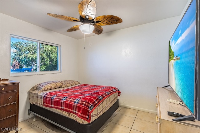 tiled bedroom featuring ceiling fan