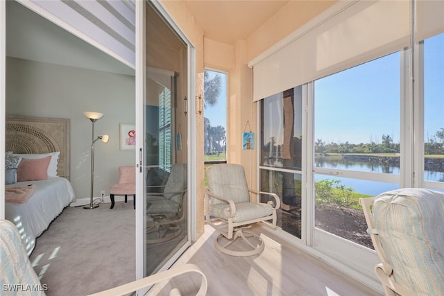 sunroom / solarium with plenty of natural light and a water view