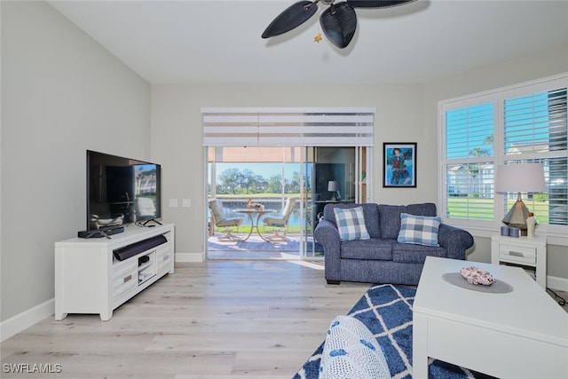 living room featuring ceiling fan, light hardwood / wood-style flooring, and a healthy amount of sunlight