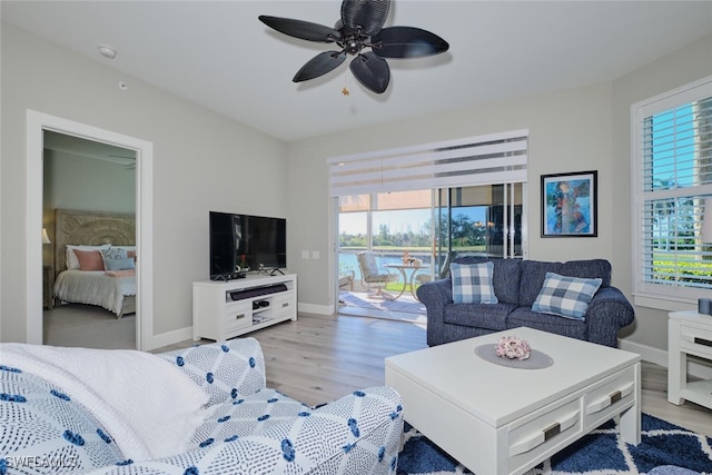 living room with light wood-type flooring and ceiling fan