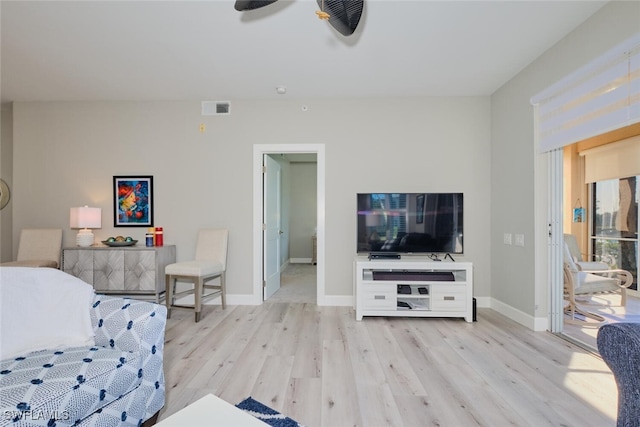 living room featuring light wood-type flooring and ceiling fan