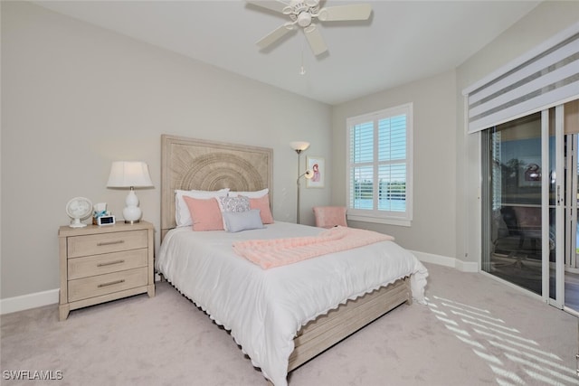 bedroom with access to exterior, ceiling fan, and light carpet