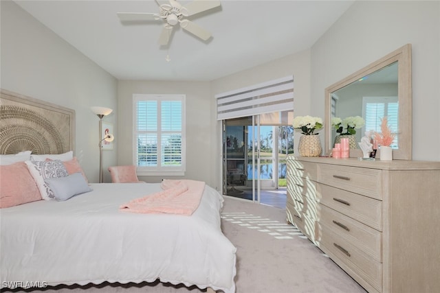 carpeted bedroom with access to exterior, multiple windows, and ceiling fan