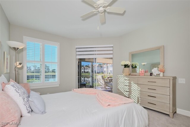 bedroom featuring access to exterior, ceiling fan, and light colored carpet