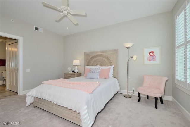 carpeted bedroom with ceiling fan and multiple windows