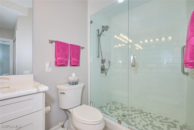 bathroom featuring vanity, toilet, and walk in shower