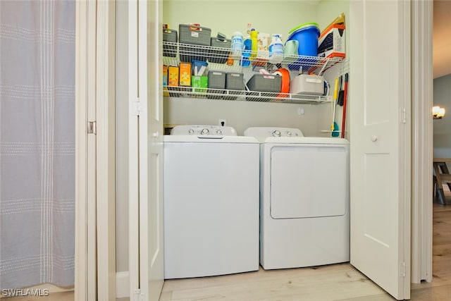 washroom featuring light wood-type flooring and separate washer and dryer