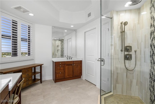 bathroom featuring ornamental molding, vanity, and a shower with shower door