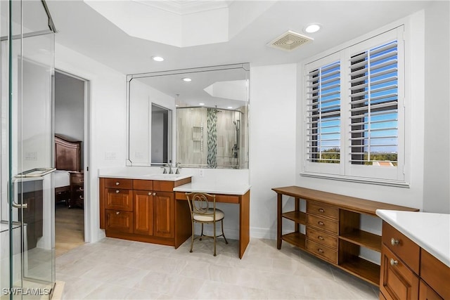 bathroom with a shower with door and vanity