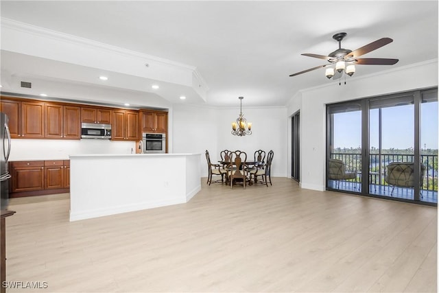 kitchen featuring light wood-type flooring, stainless steel appliances, crown molding, pendant lighting, and a kitchen island