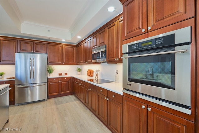 14300 Riva Del Lago Dr Unit 805, Fort Myers, FL 33907 - kitchen with appliances with stainless steel finishes, light countertops, recessed lighting, a tray ceiling, and ornamental molding