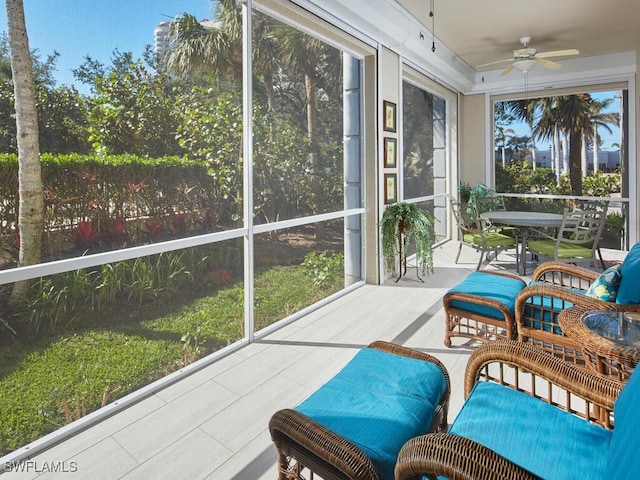 sunroom / solarium featuring ceiling fan