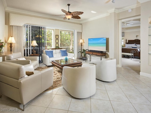 living room with ornamental molding, ceiling fan, baseboards, and light tile patterned floors