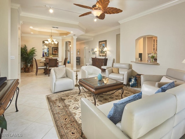 living area featuring a tray ceiling, visible vents, ornamental molding, light tile patterned flooring, and ceiling fan with notable chandelier