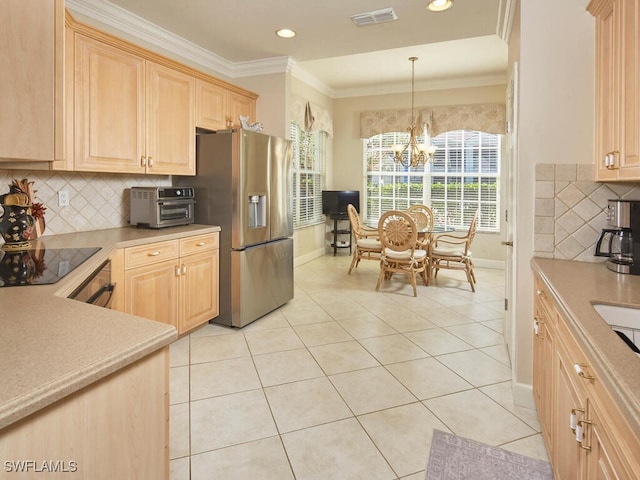 kitchen with light brown cabinets, an inviting chandelier, stainless steel refrigerator with ice dispenser, decorative light fixtures, and black electric stovetop