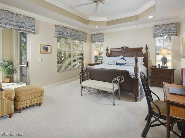 bedroom featuring carpet, a raised ceiling, ceiling fan, and crown molding